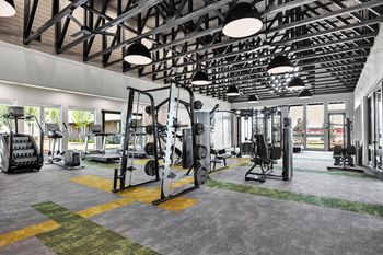 a gym with weights and cardio equipment in a building with glass doors